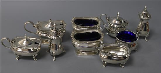 Three assorted 20th century silver three piece silver condiment sets.